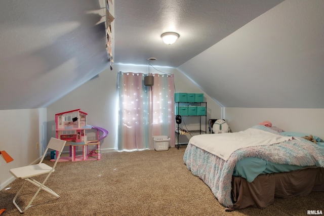 bedroom with a textured ceiling, vaulted ceiling, and carpet floors