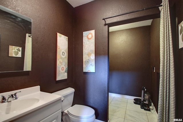 bathroom with vanity, toilet, and tile patterned flooring