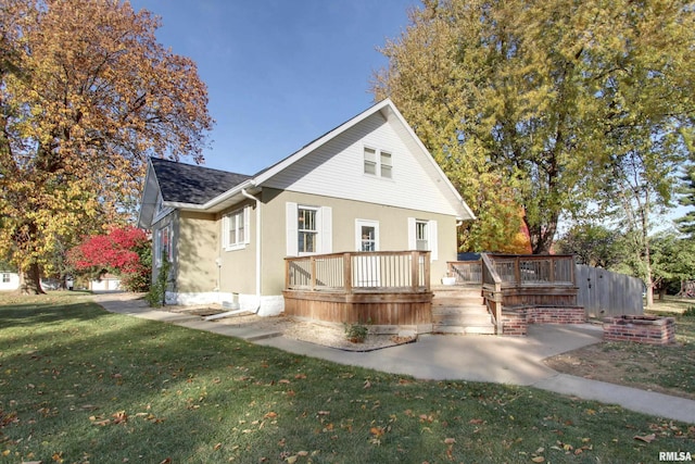 exterior space with a front yard and a wooden deck