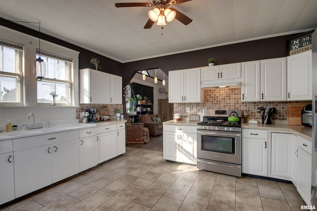 kitchen with white cabinetry, ceiling fan, and gas range