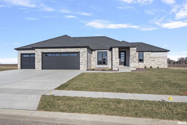 prairie-style house featuring a front yard and a garage