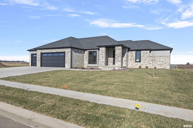 prairie-style home featuring a garage and a front yard