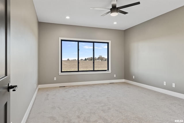 carpeted spare room featuring ceiling fan