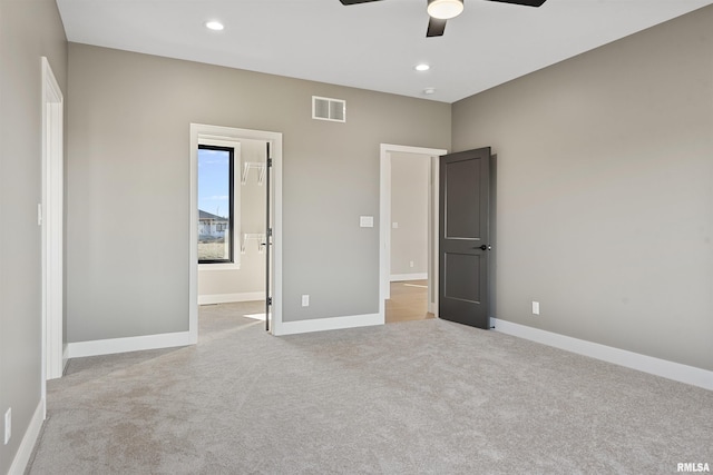 unfurnished bedroom with light carpet and ceiling fan