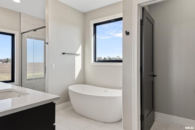 bathroom featuring vanity and shower with separate bathtub