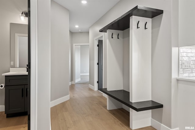 mudroom with light hardwood / wood-style floors