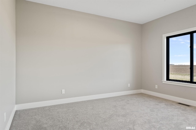 empty room featuring light colored carpet