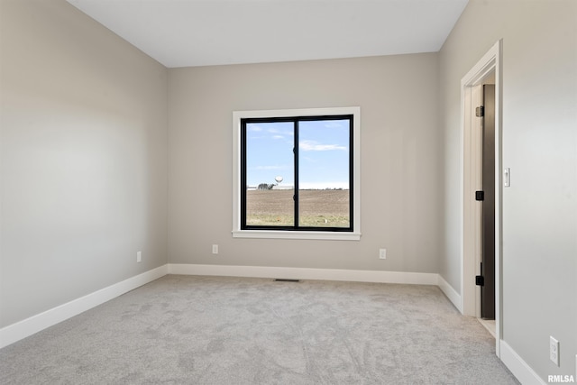 empty room featuring light colored carpet