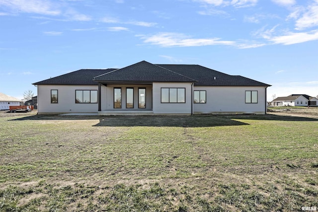 back of house featuring a yard and a patio