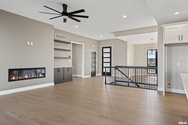 unfurnished living room featuring ceiling fan and light hardwood / wood-style floors