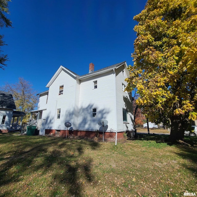 view of property exterior featuring a lawn