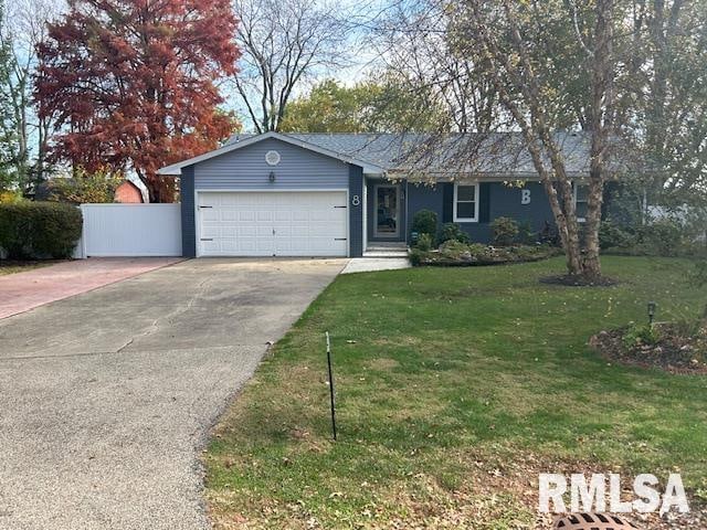 single story home featuring a garage and a front yard