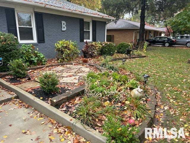 view of side of home featuring a lawn