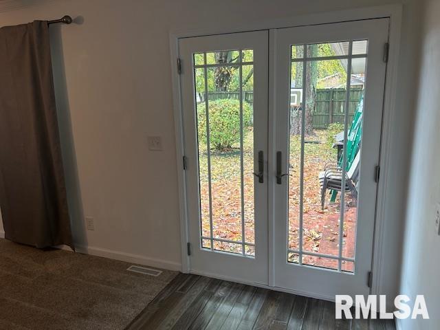 entryway featuring french doors, dark wood-type flooring, and a healthy amount of sunlight