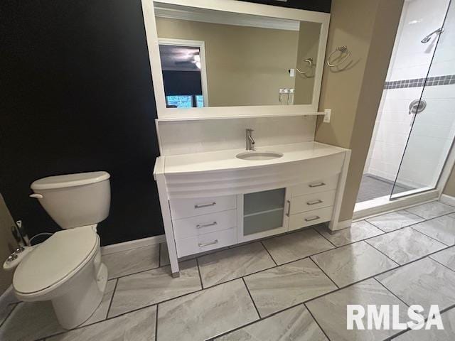 bathroom featuring vanity, toilet, and a shower with door