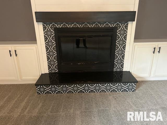 room details with carpet flooring and a tiled fireplace