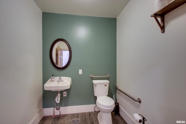 1340 Mulholland St, Nauvoo, IL 62354 - half bath with toilet, wood finished floors, baseboards, and a sink
