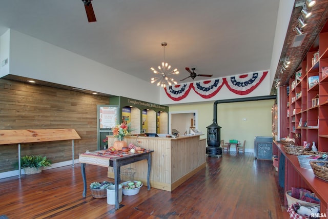 1340 Mulholland St, Nauvoo, IL 62354 - dining space featuring wood-type flooring, a chandelier, baseboards, a wood stove, and ceiling fan