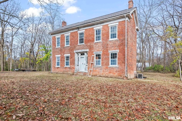 colonial house featuring central air condition unit