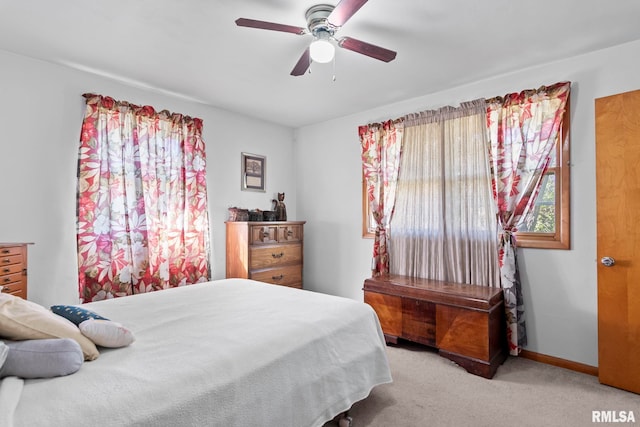carpeted bedroom with baseboards and ceiling fan
