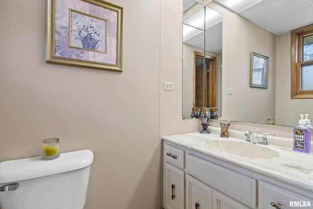 half bathroom featuring toilet and vanity