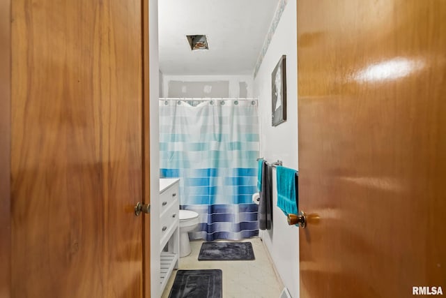 bathroom with walk in shower, vanity, and toilet