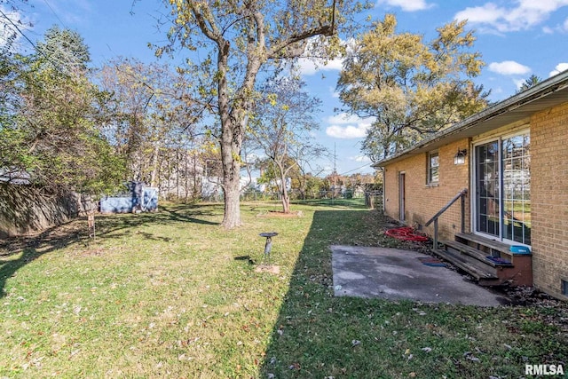 view of yard featuring a patio, fence, and entry steps