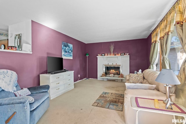 living area featuring a brick fireplace and carpet floors