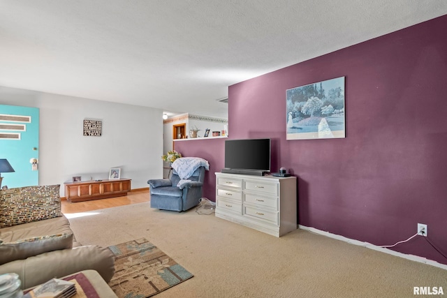 living room featuring light colored carpet and a textured ceiling