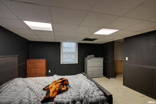 carpeted bedroom with a paneled ceiling