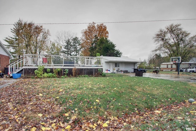 view of front facade with a front lawn and a wooden deck