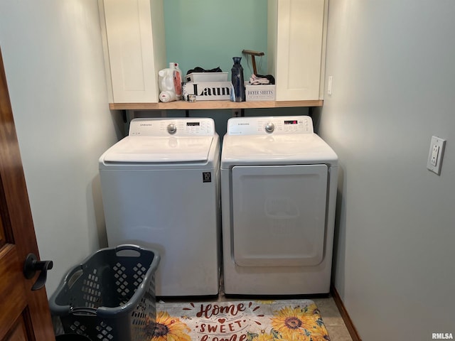 laundry room featuring cabinets and washer and dryer