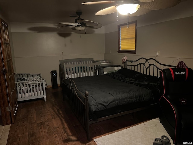 bedroom featuring dark hardwood / wood-style flooring and ceiling fan