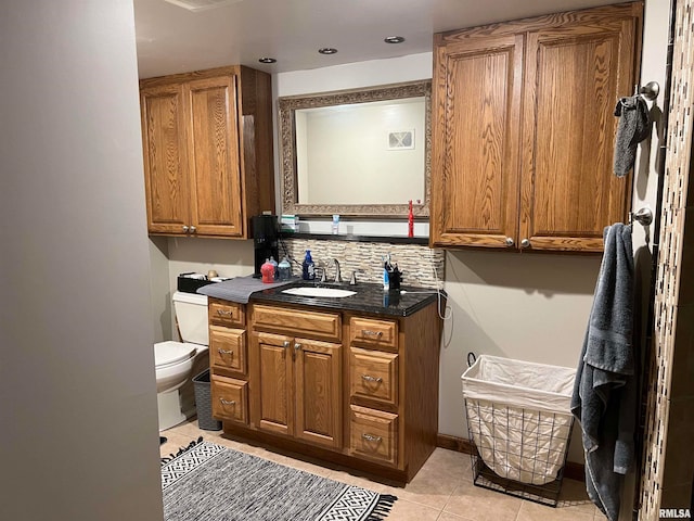 bathroom featuring vanity, tile patterned floors, toilet, and backsplash