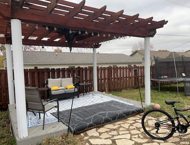 view of patio / terrace with a pergola and a trampoline