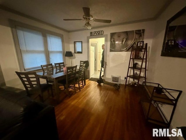 dining room featuring ornamental molding, hardwood / wood-style flooring, and ceiling fan