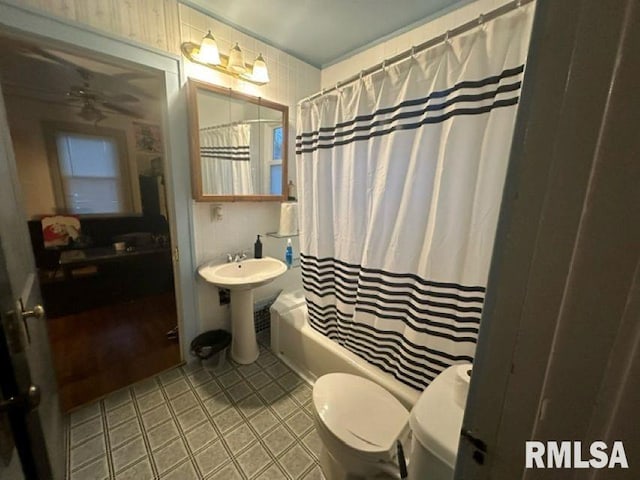 full bathroom featuring toilet, sink, and shower / bath combination with curtain