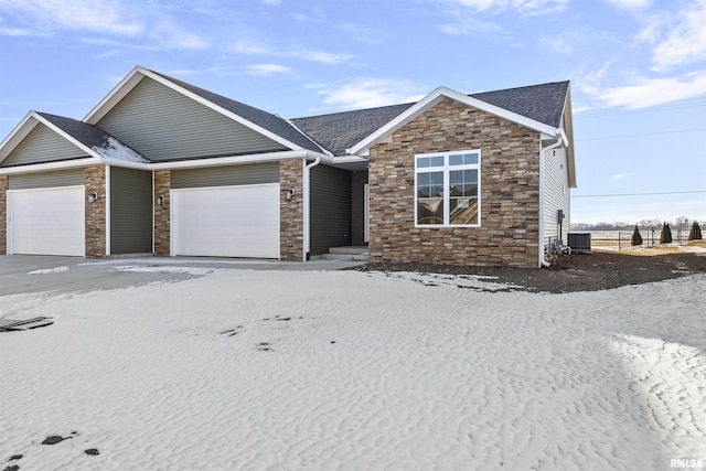 view of front of property with a garage and central AC unit