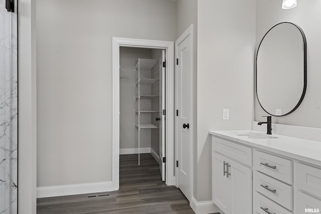 bathroom with vanity and hardwood / wood-style floors