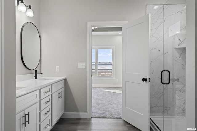 bathroom with vanity, hardwood / wood-style flooring, and walk in shower