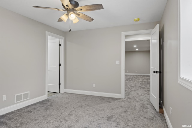 unfurnished bedroom with ceiling fan and light carpet