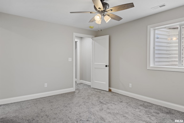 unfurnished bedroom featuring light carpet and ceiling fan