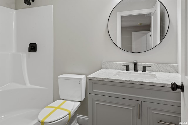 bathroom featuring walk in shower, vanity, and toilet