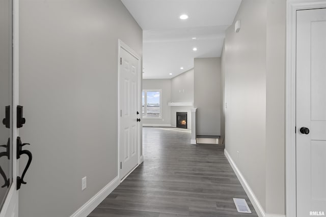 hallway with dark hardwood / wood-style flooring
