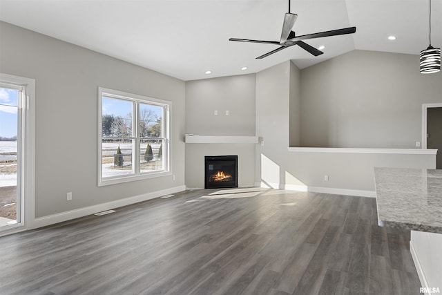 unfurnished living room with dark hardwood / wood-style flooring, vaulted ceiling, and ceiling fan