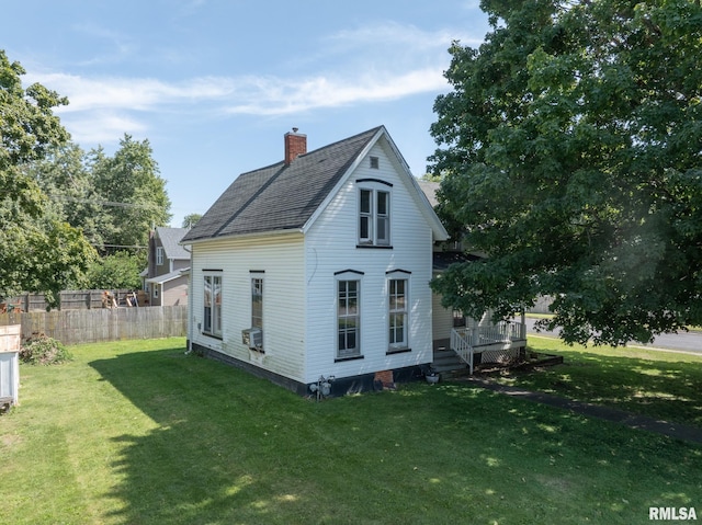 rear view of property with a lawn