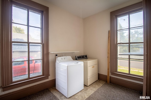 clothes washing area with a wealth of natural light and separate washer and dryer