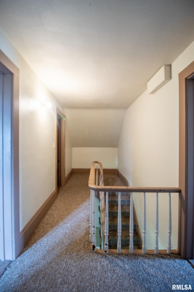 staircase with vaulted ceiling and carpet floors