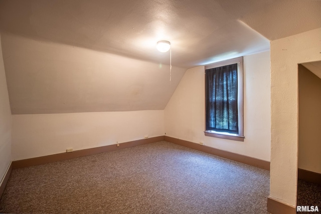 bonus room featuring carpet, a textured ceiling, and vaulted ceiling