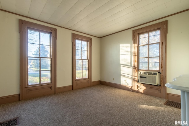 unfurnished room with plenty of natural light, carpet flooring, and cooling unit